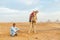 Herder with camel near the pyramids at Giza