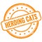 HERDING CATS text on orange grungy round rubber stamp