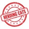 HERDING CATS text on red grungy round rubber stamp