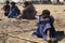 Herdsman sitting with tied knees in the desert of