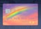 Here is a credit card that has a rainbow design and colors and is to be used on a rainy day