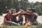 Here we meet again. Group of people have picnic on the beach. Friends have fun at weekend time