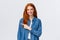 Here what need. Cheerful redhead woman in denim shirt, pointing finger left copy space, smiling recommend good product