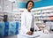 Here youll find a pharmacist you can trust. a female pharmacist working in a drugstore.