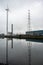 Herentals, Antwerp Province, Belgium - Reflections of a windmill electricity generator and high voltage wires and transmissions