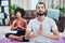 Heres the secret to a successful relationship. a young couple practising yoga in their living room.