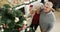 Heres to another Christmas with you. 4k video footage of an affectionate senior couple standing together and decorating
