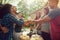 Heres to awesome food with awesome friends. a group of friends having lunch in their backyard.