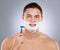 Heres what well need. a man with shaving foam and his face while holding a razor.