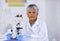 Heres where scientific breakthroughs start. A female scientist sitting behind her microscope.