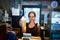 Heres your order. Portrait of a young barista holding up a chilled coffee beverage in a coffee shop.