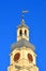 Heritage golden spire aka spile on the vintage building roof on blue sky in sunny day, travel diversity,