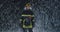 Hero shot, portrait of tired American female firefighter standing taking off her protective helmet, looking into camera