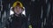 Hero shot, portrait of tired American female firefighter standing taking off her protective helmet, looking into camera