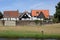 Heron in front of picturesque half-timbered decorative houses in Westerholt village in Herten, North Rhine-Westphalia, Germany