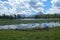 Heron Pond and Jackson Lake with water lilies and reflections of beautifully structured clouds.