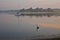 Heron in the waters of Buzzard Bay at sunrise. Beautiful early morning mood. Onset, Massachusetts, USA.