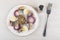 Herring with boiled eggs, red onion in plate, pepper