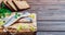 Herring fillet with parsley and onion on a cutting board, close-up, dark wooden background. Traditional Norwegian or Danish