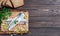 Herring fillet with parsley and onions on a cutting board, top view, dark wooden background. Traditional Norwegian or Danish