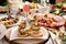 Herring and pickle rolls and other appetizers on Christmas table