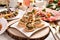 Herring and pickle rolls and other appetizers on Christmas table