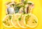 Herring salad with lemon on a yellow background