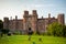 Herstmonceux, East Sussex, England. Brick Herstmonceux castle in England East Sussex 15th century. Birds of prey and view of