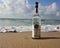 Herzelia, Israel. December 17, 2016. Bottle of Beluga vodka in water, beach sand and wave seashore background. Waves wash a glass