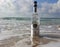 Herzelia, Israel. December 17, 2016. Bottle of Beluga vodka in water, beach sand and wave seashore background. Waves wash a glass