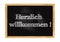 Herzlich willkommen - Welcome in German blackboard notice Vector illustration