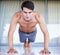 Hes always challenging himself. A portrait of a focused young man doing strength exercises at home.