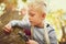 Hes full of curiosity. Shot of an inquisitive little boy exploring the woods with a magnifying glass.