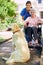 Hes her most trusted friend. a resident, her dog and a nurse outside in the retirement home garden.