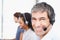 Hes here to answer all your questions. Closeup portrait of a call center professional with colleagues seated in the