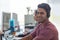 Hes next in line for a promotion. Shot of a young man wearing a headset with his colleagues blurred in the background.