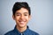 Hes one super confident kid. A cute young preteen boy standing and smiling against a grey background.