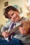 Hes a talented young musician. Portrait of a little boy playing an electric guitar at home.