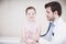 Hes always very thorough when doing checkups. a doctor doing a general medical examination on a little girl.