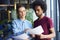 Heterosexual couple analyzing important documents in the office