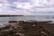 Heugh breakwater pier from shore in stormy, cloudy weather seascape