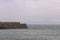 Heugh breakwater pier in stormy, cloudy weather seascape