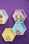 Hexagon shaped shelves with toys on wall. Interior design