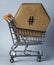 A hexagonal cardboard box inside a shopping trolley.