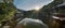 Hexagonal Gazebo Ukimido in the central pond of Mejiro Garden where ducks are resting and which is surrounded by large rocks and