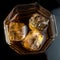 Hexagonal glass of whiskey with three cubes of real ice top view