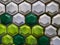Hexagonal shaped old plain green white tiles, creating a ceramic pattern