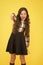 Hey you. Manners of hothead. Girl long hair cool pointing forward. Child pointing camera yellow background. Kid pointing