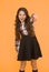 Hey you. Manners of hothead. Girl long hair cool pointing forward. Child pointing camera yellow background. Kid pointing