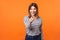 Hey you! Portrait of adorable positive woman with brown hair in long sleeve striped shirt. indoor studio shot isolated on orange